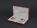 two silver spoons in a red box on a black surface