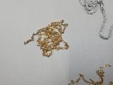 three different types of necklaces on a white surface
