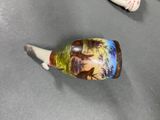 a small vase that has a picture of a man and a woman on it