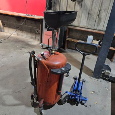 a fire extinguisor sitting on a cart in a garage