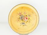 a yellow plate with a floral design on it
