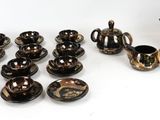 many pieces of pottery that are sitting on a table