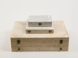 two pieces of cardboard sitting on top of each other on a white surface