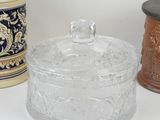 three glass containers with lids and lids are sitting on a white surface