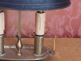 a lamp that is sitting on a table with a blue shade on it