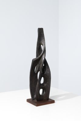 a black sculpture on a white table with a white background