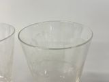 two glasses sitting next to each other on a table