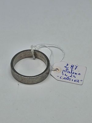 a ring with a tag attached to it on a table