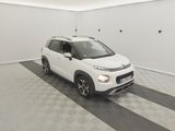 the small white car is parked in the garage on the checkered floor