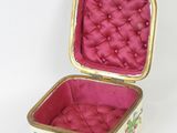 a small pink box with a floral design on it