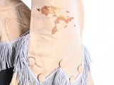 someone is wearing a tan jacket with a map on it