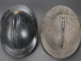 pair of silver hard hats sitting on top of a gray surface