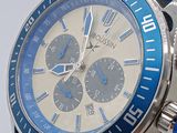 a close up of a watch with a blue band
