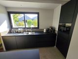 a kitchen with black cabinets and black appliances in it