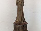 a gold colored lamp that is sitting on a table