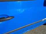 a close up of a blue car door handle