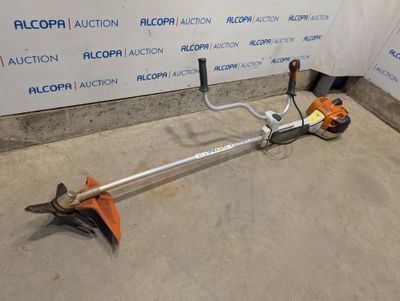 an image of a lawn mower that is on the ground