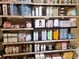 a lot of bottles and containers on the shelves in the store