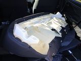 a car seat with a bag in it in the back of a car