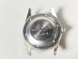 a close up of a watch on a white surface