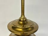 a gold vase with a clock on top of it