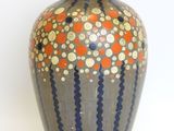 a vase that is sitting on a white surface