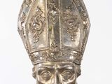 silver statue of a man with a hat and a beard