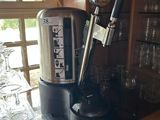 a coffee maker sitting on top of a wooden counter