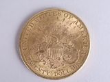 a gold coin on a white surface with a white background