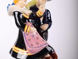 a figurine of a man and a woman on a rock