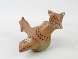 a small figurine of a cat on a white surface