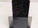 someone is taking a picture of a cell phone on a stand