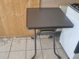 a small table that is on the floor in the kitchen