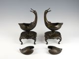 pair of bronze birds on pedestals with legs and feet