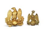 pair of gold eagle figurines on a white background