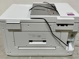 a white printer sitting on top of a white table