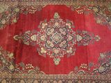 an oriental rug with a medallion design on a red background