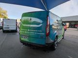 a van parked under a blue umbrella in a parking lot