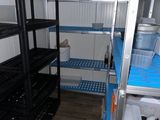a small room with a lot of shelvings and shelves