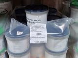 many buckets of paint on the shelf in the store
