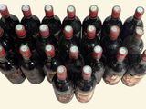 many bottles of wine lined up together on the table
