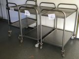 three stainless steel trolleys sitting in the middle of a room