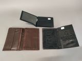 three leather wallets sitting next to each other on a table