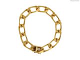 a close up of a gold chain bracelet on a white background