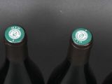 five wine bottles with green lights on them