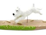 a figurine of a dog that is running on the ground