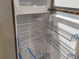 a refrigerator that has been taped up and is in the process of being remodeled