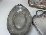 two silver trays and a silver tray on a table