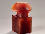 an image of a sculpture of a mushroom sitting on top of a wooden block
