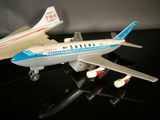 two model airplanes sitting on a black surface